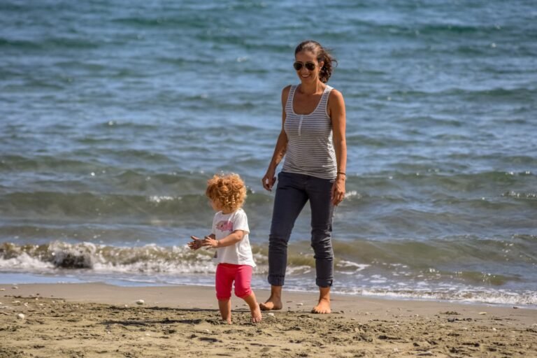Mom walking on beach with kids